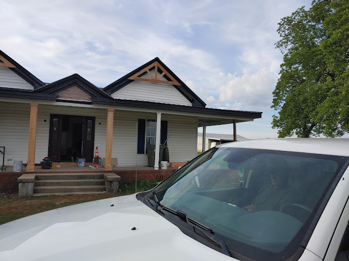 A white car parked in front of a house