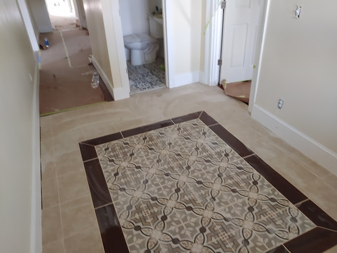 A bathroom with a toilet and a rug on the floor