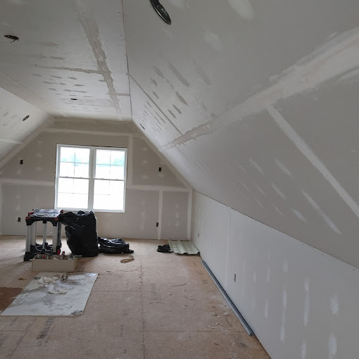 A room that has been painted white and is being worked on